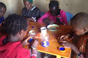 Angaza girls making beads