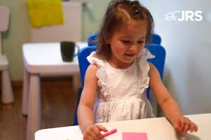 Girl focusing on bright educational materials