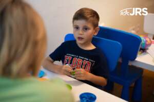 Boy concentrating during a speech therapy session.