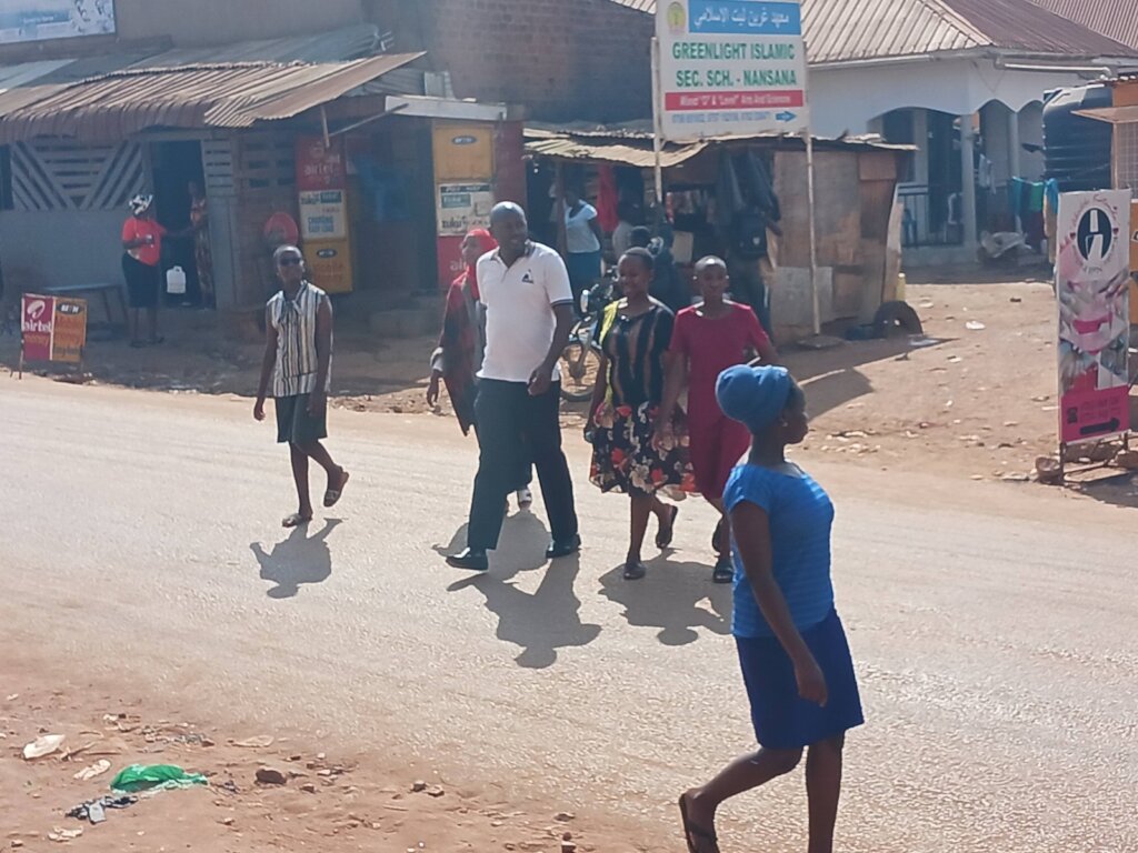 A volunteer Demonstrating how to cross a busy road
