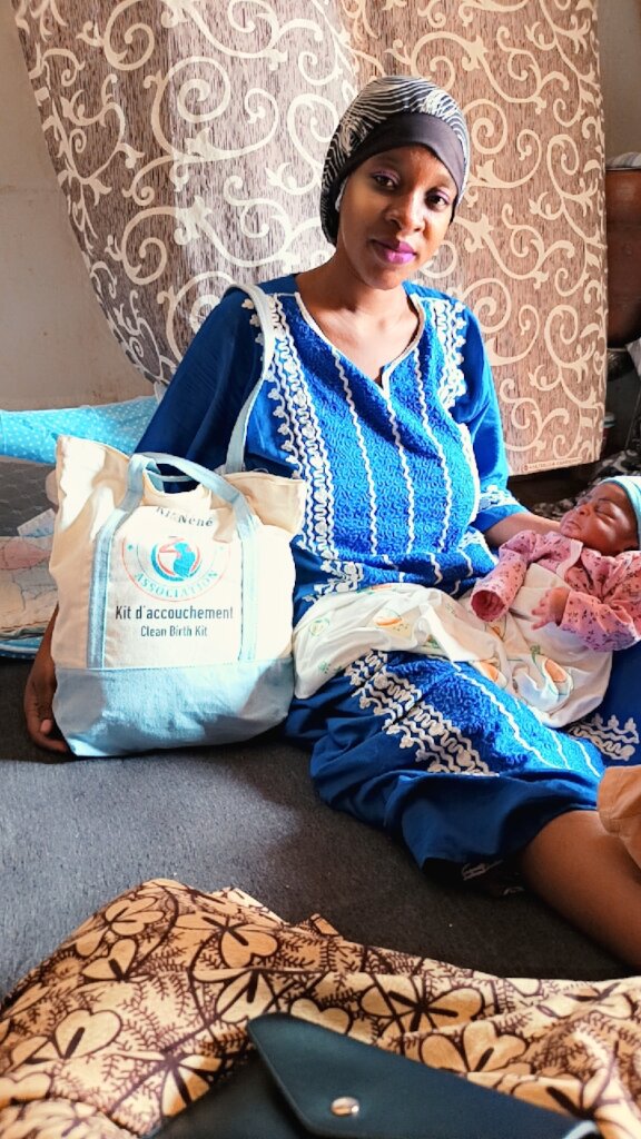 A happy beneficiary and her baby
