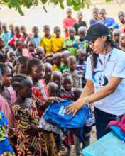 Students receiving their school uniform and bag