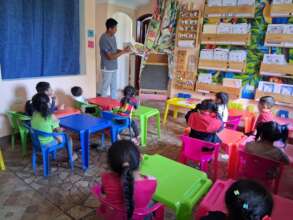 Teacher reading students a children's book