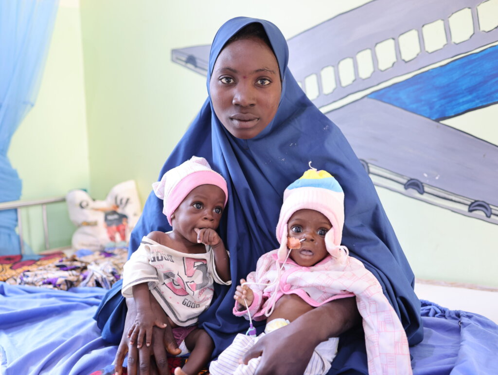 Mother with her twin babies receiving medical care