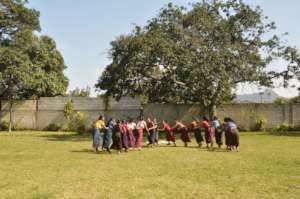 The women participate in a game
