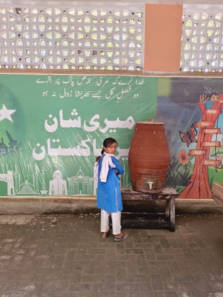 Students drinking water from container