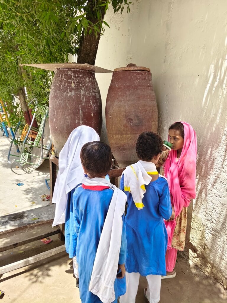 Students drinking water from container