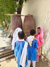 Students drinking water from container