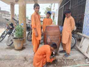 Students drinking water from container