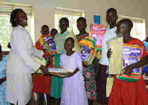 Program officer handing over scholastic materials