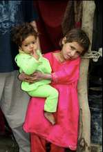 Shabana at home carrying for a younger sibling