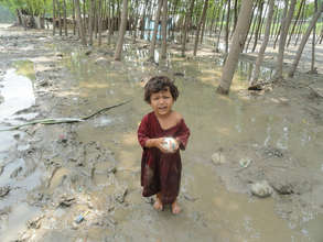 A child playing in her flood-affected neighborhood