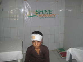 Child with bandaged head wound  SHINE -Aasra Gha