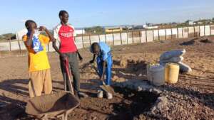 Learners mixing cement
