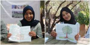 Proud Dar Taliba students show their drawings