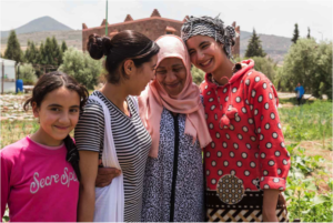 Saida shares a moment with three young gardeners