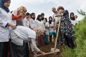 Planting a tree in the new garden at Dar Taliba