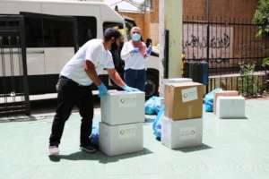 TYO staff delivering food to families in need.