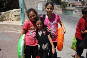 Friends head to the pool during summer camp