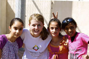 Intern Liz smiles with some of her students.