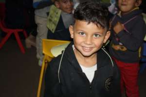 A TYO student smiles in his bee wings.