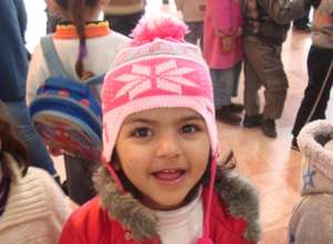 A Core Program participant grins in fuzzy new hat