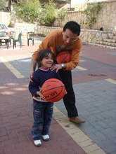 Volunteer teaches how to "shoot hoops"!