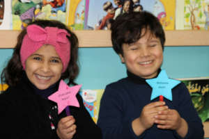 Mo'men & Yara are all giggles showing their signs!