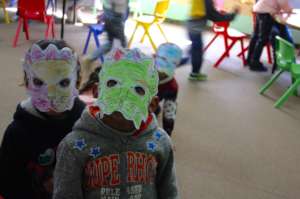 Students show off their lion masks in EFL class.
