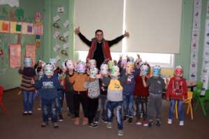 Teacher Mahmoud and students roar in lion masks.