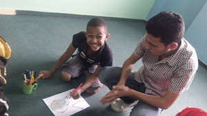 Rafat draws an emotion portrait in drama class
