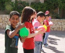 TYO student Yoseph holds his water balloon.