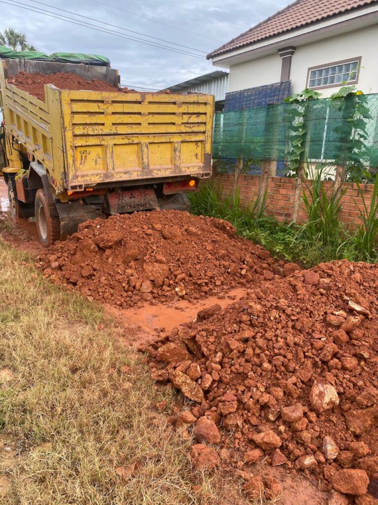 trucks carry read soils and earth to broken parts
