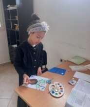 One of the beneficiaries doing art activity