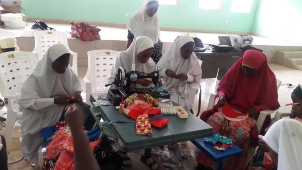 Students learning how to sew sanitary pads