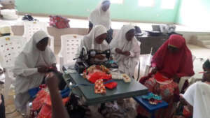 Students learning how to sew sanitary pads