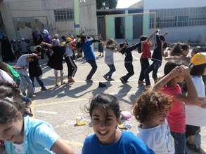 Youth play outdoors during summer camp