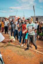 Community members receiving fresh vegetables