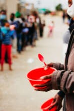 Children waiting in line at a soup kitchen