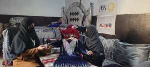 A project participant showing the clothes she made