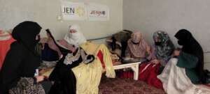 A project participant showing the clothes she made