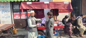 A male participant selling baby winter sweaters