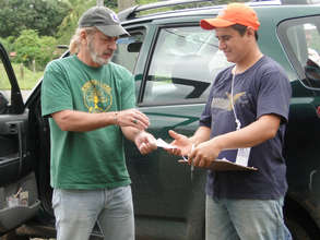 Deibys Villalobos being paid for his cacao trees