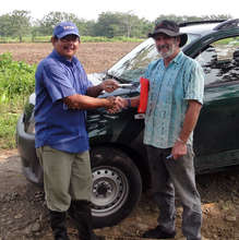 Alexis Vela receiving a check from Daniel Spreen