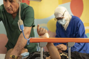 Hospital staff at work with a little patient