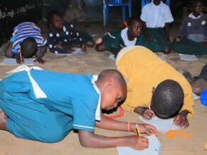 Learning writing on the floor with no desks