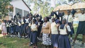 Girls pose with donated reusable sanitary pads.