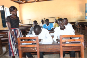 An intern assists a participant during a workshop