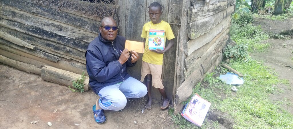 Sarah Receiving Her School Fees from PLANE Officer