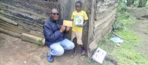 Sarah Receiving Her School Fees from PLANE Officer